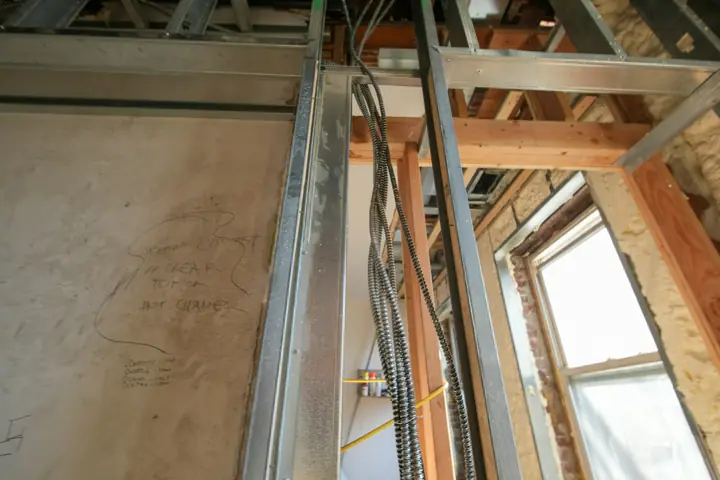 Rough-in electrical work on a framed construction site